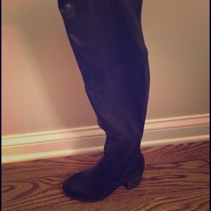 Knee high black leather boots. Never worn.