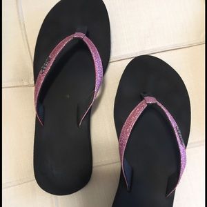 Reef pink and black flip flops