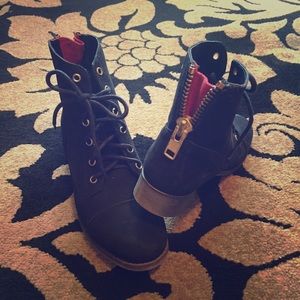 Steve Madden boots with gold/red back zip detail.