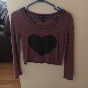 a purple shirt with a black heart in the middle