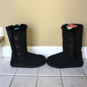 Black tall UGGs with wooden button closures