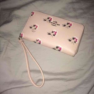 Coach floral wristlet. Minimal damage shown in pic