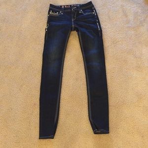 Rock Revival Buckle skinny jeans.