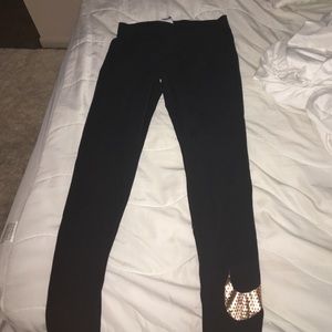 Black Nike Legging with Gold Swoosh on ankle