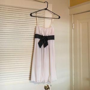 Beautiful white mini dress with black bow and sash