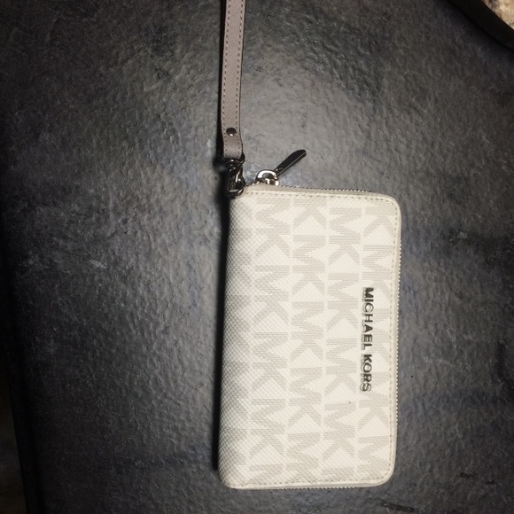 Grey and white Michael Kors wrist wallet.