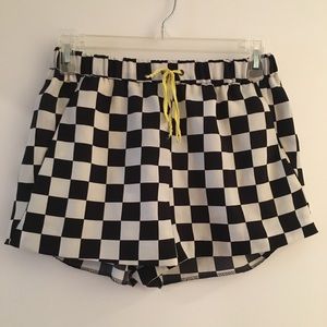 Black and white checkered shorts with yellow tie