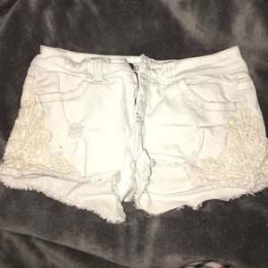 White jean shorts with lace detailing