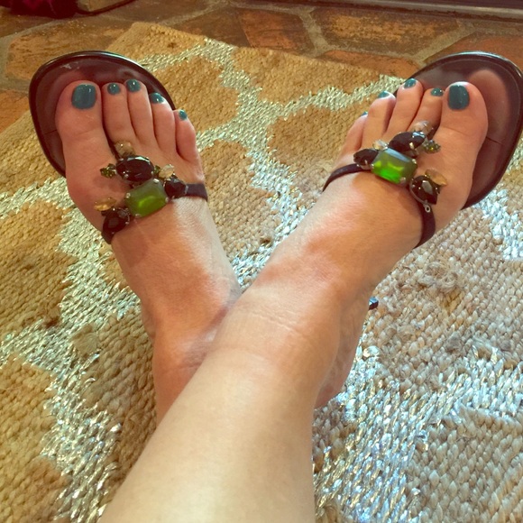 Black satin strapped mules with glamorous jewels.
