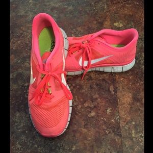Coral Nike 5.0 Free Runs shoes.