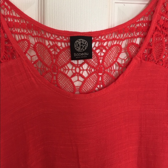 Coral top with crochet detail.