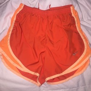 Orange Nike running shorts
