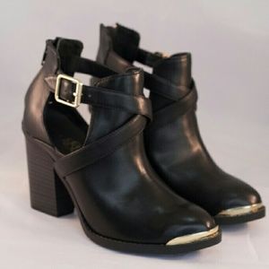 Black leather booties with gold accents