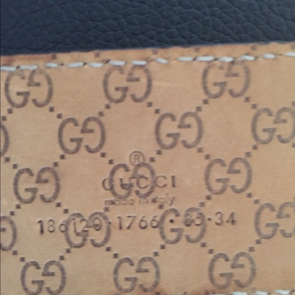 Black patent Gucci belt with gold metal bow