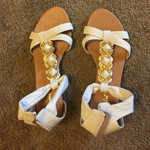 White sandals with gold jewels and slight heel
