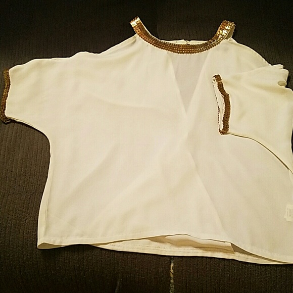 White and gold flowy blouse with open back