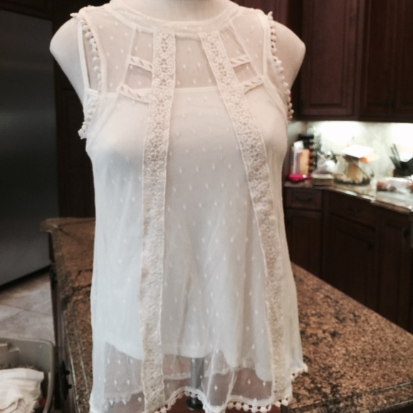 Sheer lace top with tank underneath.