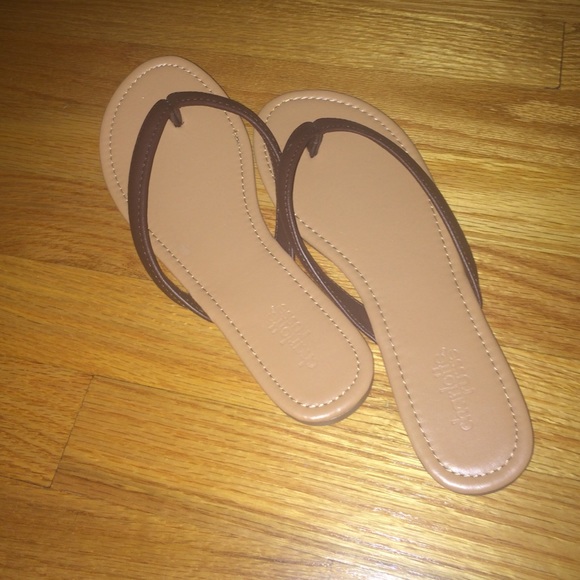 Tan and brown flip flops