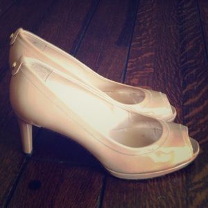 Stuart Weitzman nude peep toe pumps.