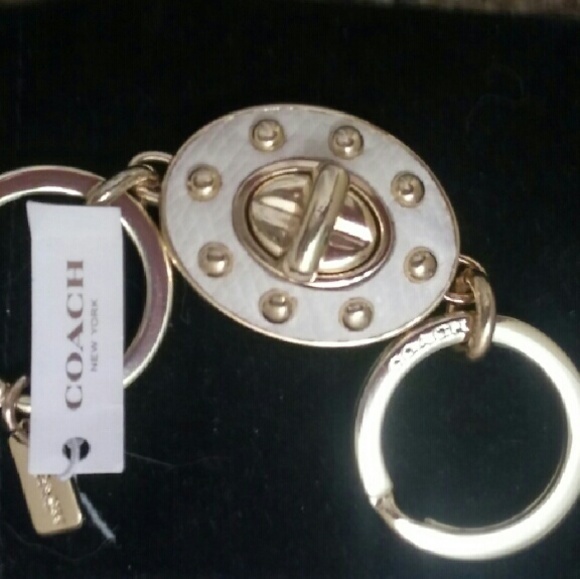 White leather riveted turnlock keychain