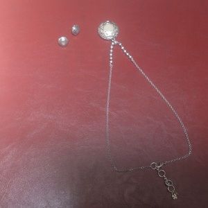 Silver pendant necklace with matching earrings.