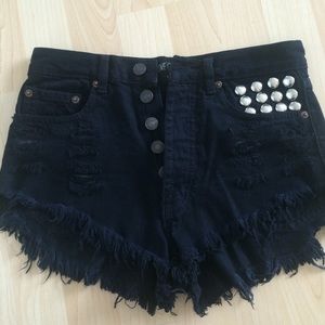Distressed high waist black shorts with studs.