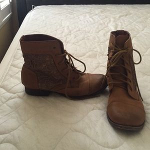 Light brown booties with floral lacing on the side
