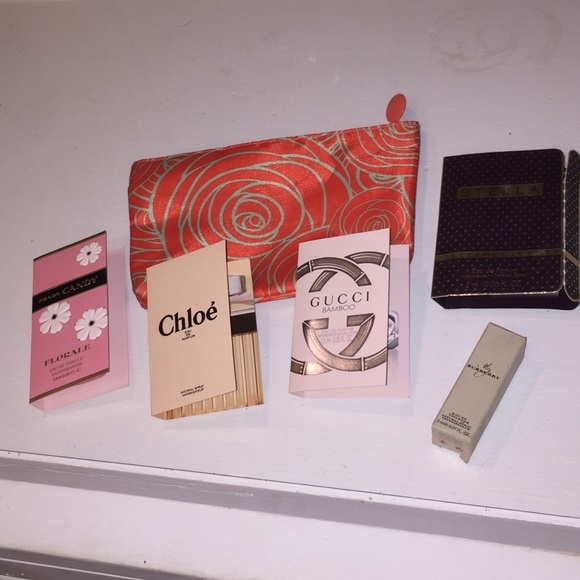 Five piece sample perfume set plus a make up bag
