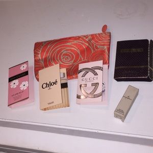 Five piece sample perfume set plus a make up bag