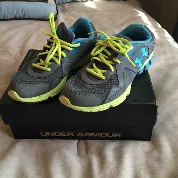 Under Armour grey, blue and yellow shoes.