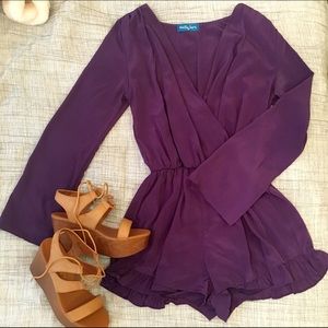 Deep V purple romper with ruffle detail