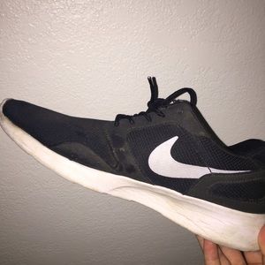 Black nikes with white nike symbol