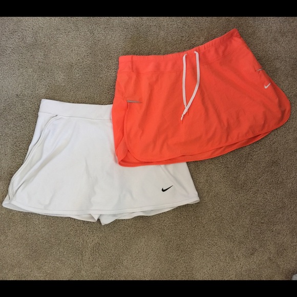 2 Nike DriFit skorts bundle (1 orange, 1 white)