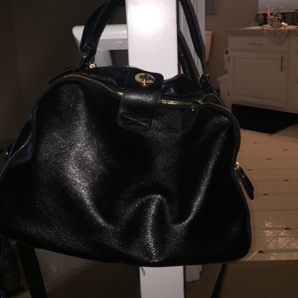 Black across the body bag. 13 inch width.