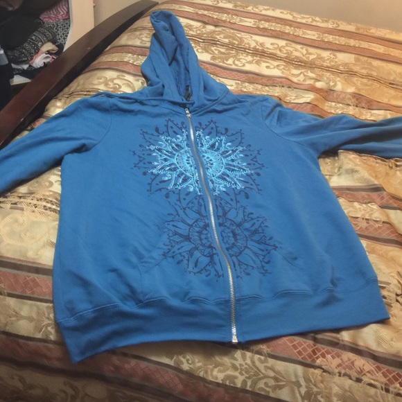 a blue jacket with a flower design in the middle
