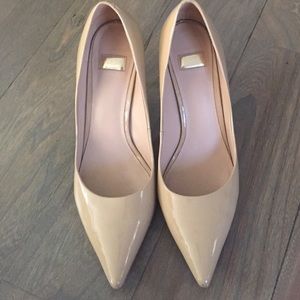 Marciano patent leather nude pumps.