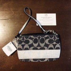 Authentic Coach wrist wallet with tags.