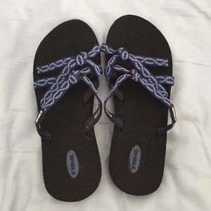 Black and blue Teva slides