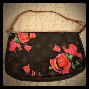 Small, floral Louis Vuitton handbag.