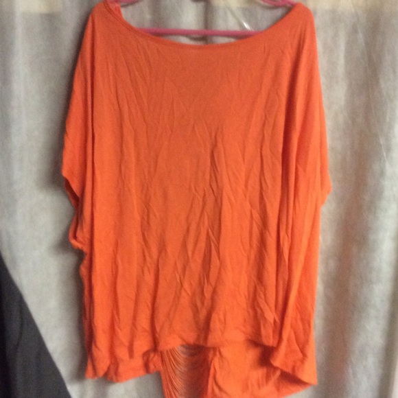 Lush orange shirt with fringe back.