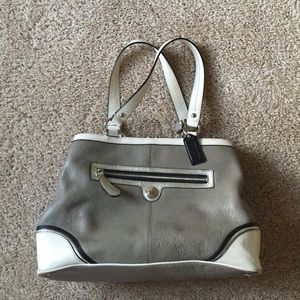 Tri colored coach purse with middle compartment.