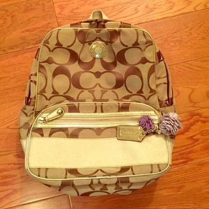Small, gold Coach book bag