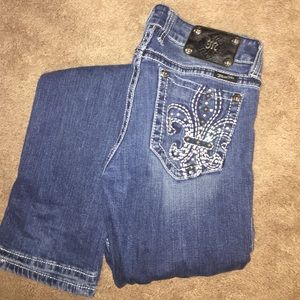 Miss Me Fleur-de-lis bedazzled straight leg jeans.
