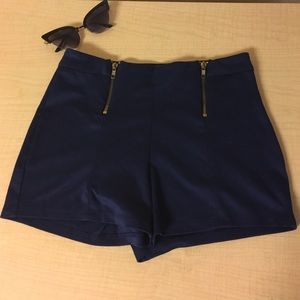 Navy blue shorts with gold zippers