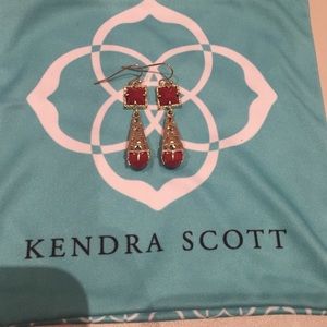 Gold Kendra Scott earrings with red stone.