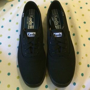 Women's black Keds.