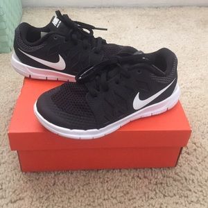 Nike black and white (boy or girl ) shoes.