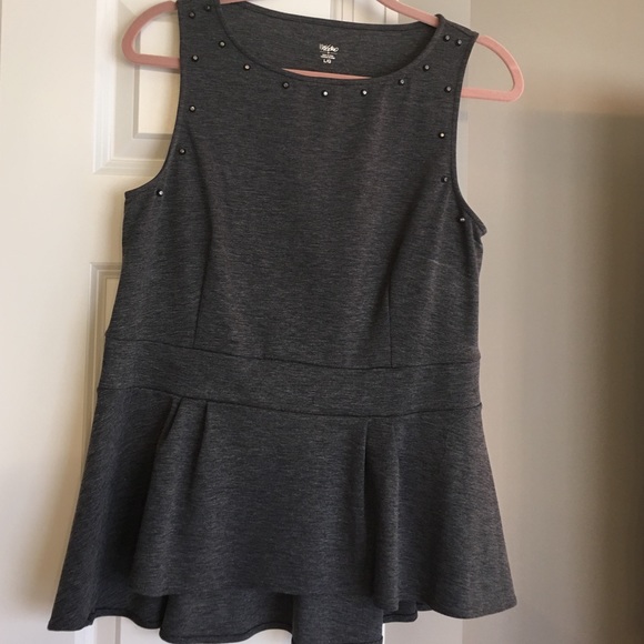 Sleeveless top with front grommets.