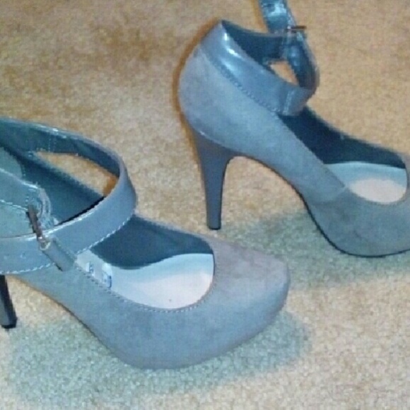 Grey platform pumps with a strap around the ankle