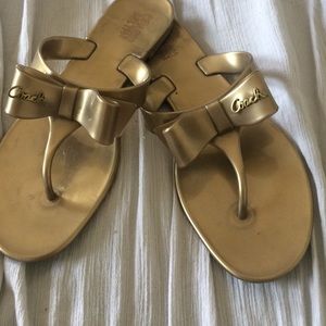 COACH gold bow flip flops